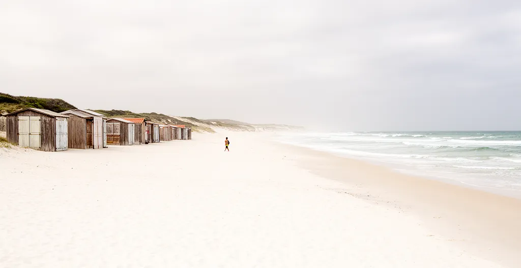 Quiet sandy beach with wooden beach huts on Île de Ré